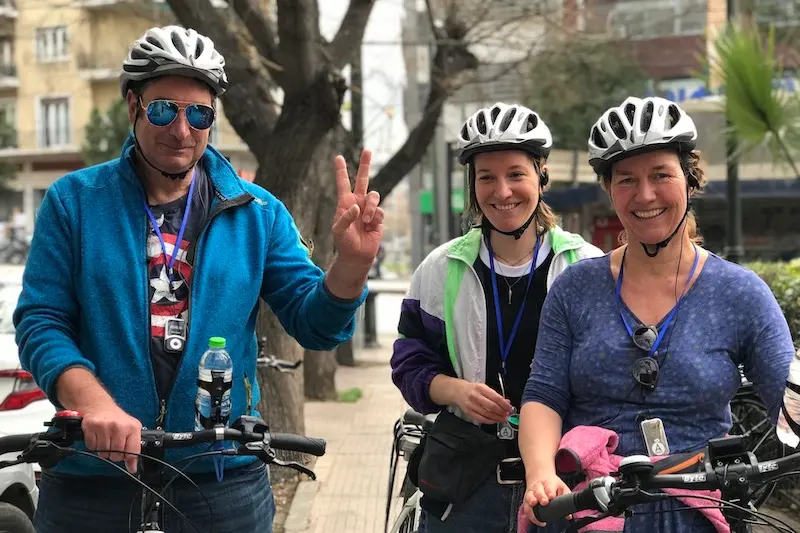 A family of adult travelers preparing to start an Athens e-bike tour outside the Solebike office near the Acropolis.