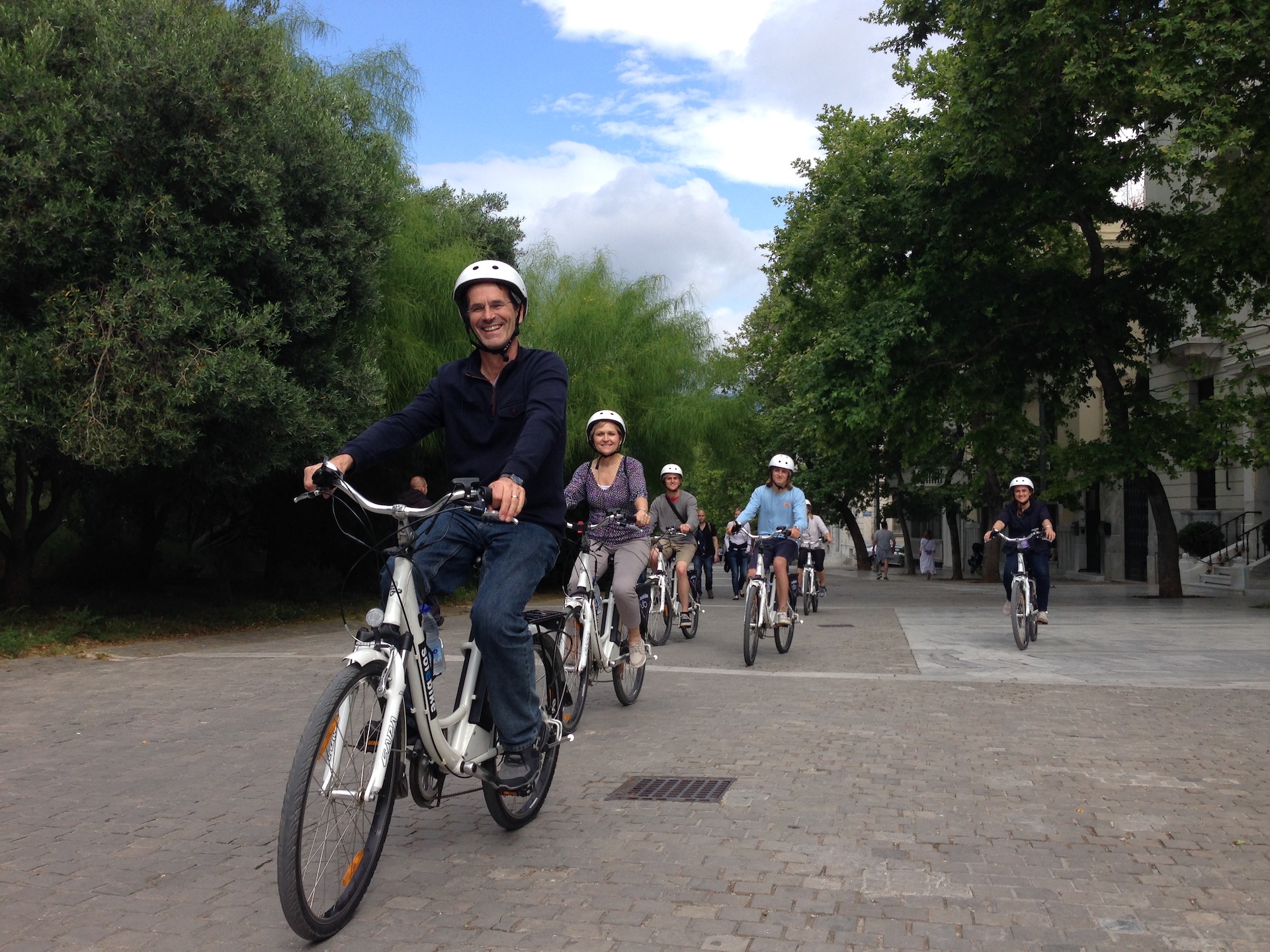 family loves the e-bike flow in old Athens street