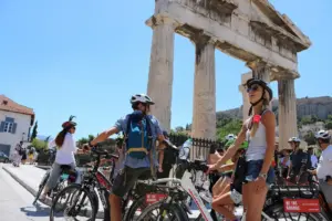 Ancient marble ruins and the Tower of the Winds at the Roman Forum in Athens seen from a pedestrian bike path.