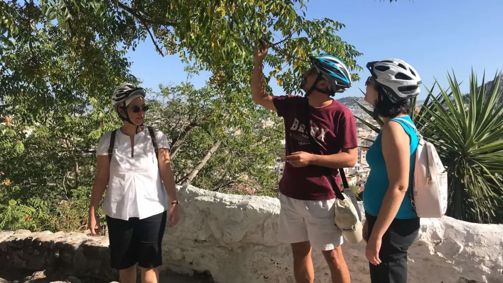 Riders exploring Anafiotika alleys on foot during an eBike tour in Athens