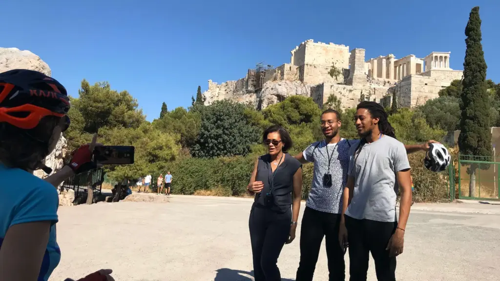 Tour guide taking a family photo below the Acropolis during an Athens eBike tour