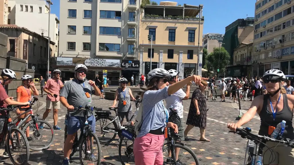 Guided bike tour group stopping in central Athens before continuing the ride