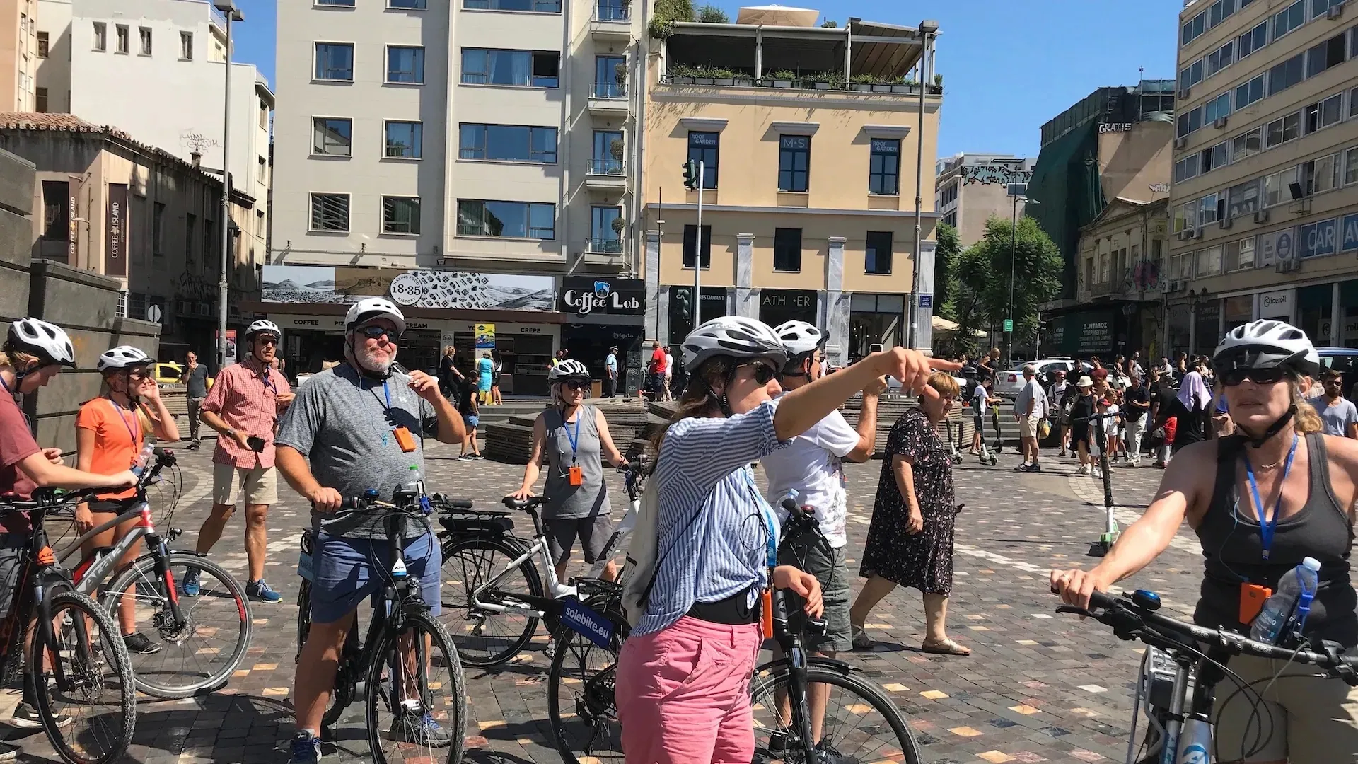 Guided bike tour group stopping in central Athens before continuing the ride