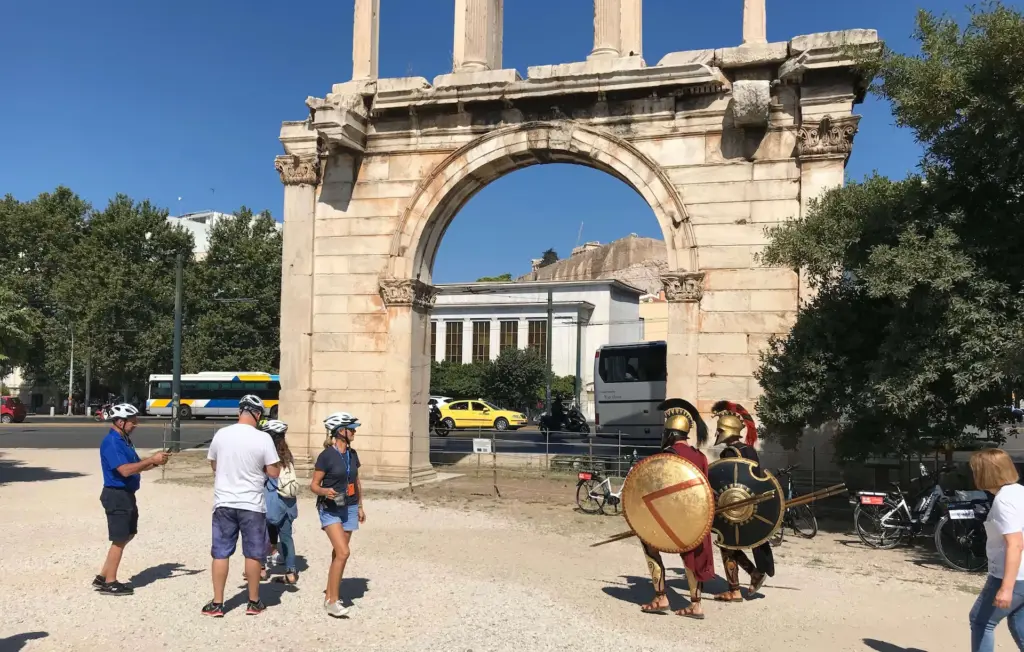 eBike tour group at Hadrian’s Gate watching men dressed as ancient Greek warriors