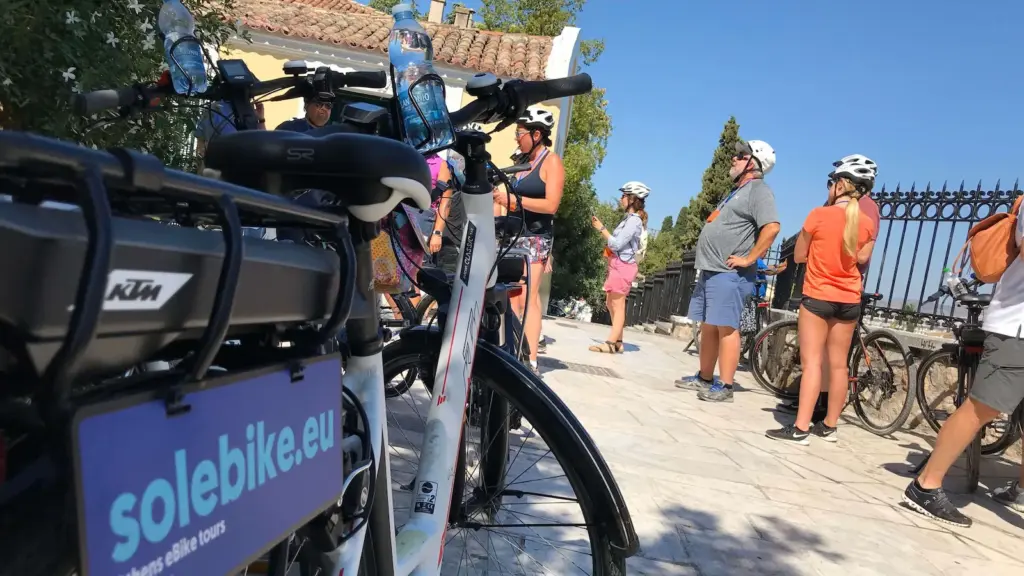 eBike tour group taking a photo stop at the Roman Agora during an Athens shore excursion