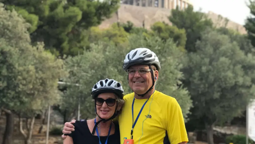 Senior couple smiling during an Athens shore excursion stop below the Acropolis