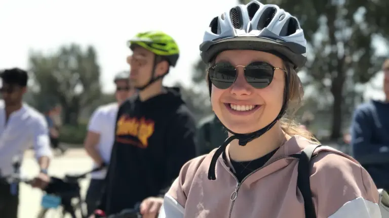 Smiling woman wearing a helmet on an Athens eBike tour