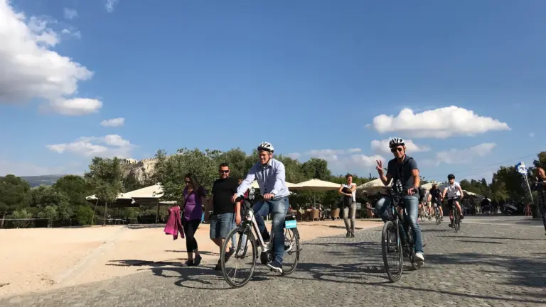 Riders on an eBike tour in Thissio with the Acropolis in the background