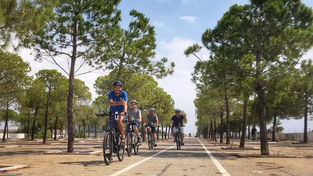 Cyclists riding along the tree-lined Faliro promenade during the Athens Riviera Coffee Ride eBike tour