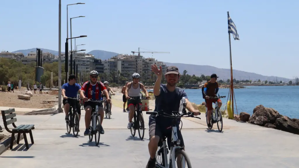 Athens Riviera Coffee Ride group cycling beside the sea on Faliro promenade