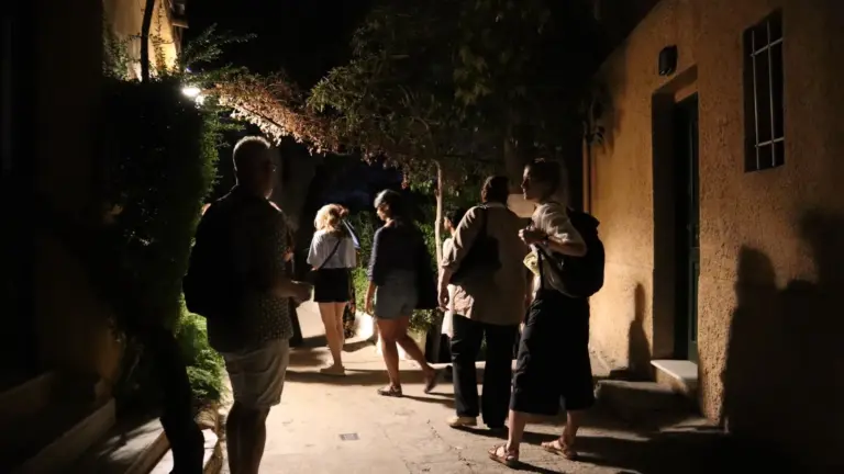 Participants exploring Anafiotika during a late evening architectural walking tour in Athens