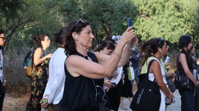 Participants using audio headsets during an academic architectural walking tour in Athens